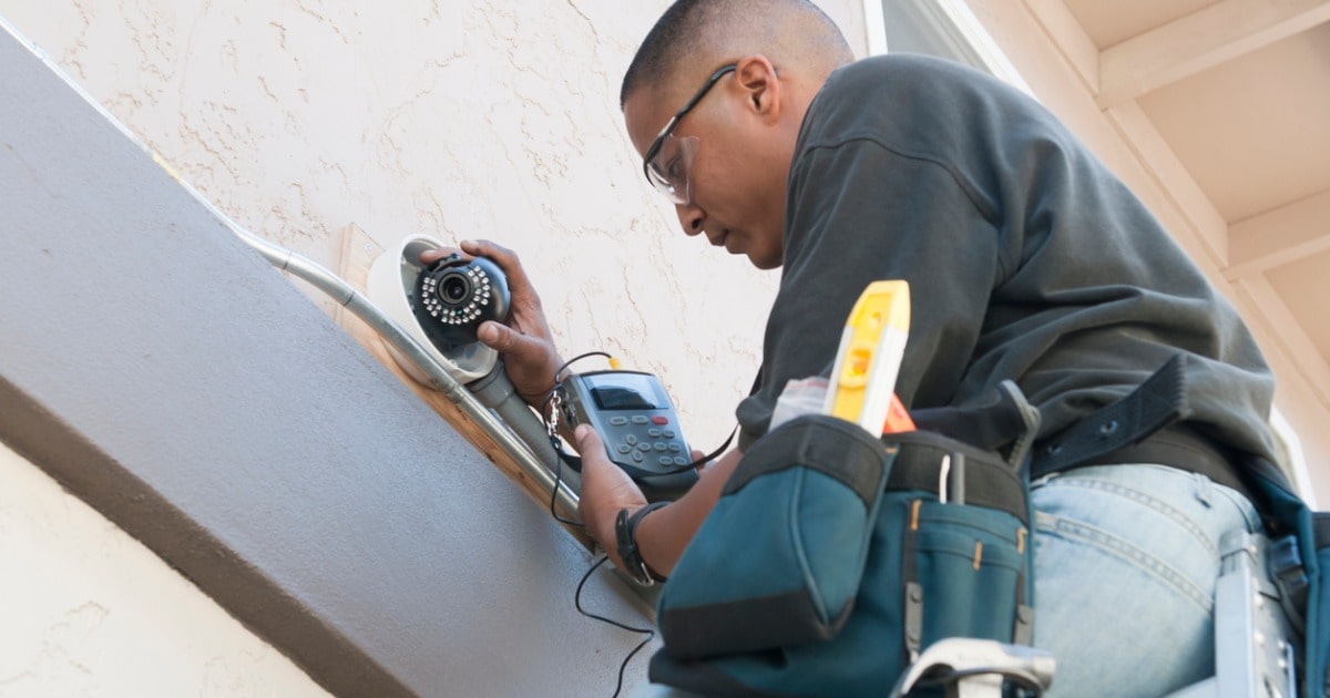 technician installing security camera